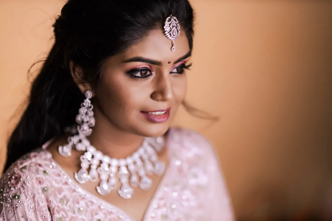 Bride looking over her shoulder, crystal choker catching the light