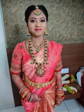 Bride in coral silk with temple jewellery